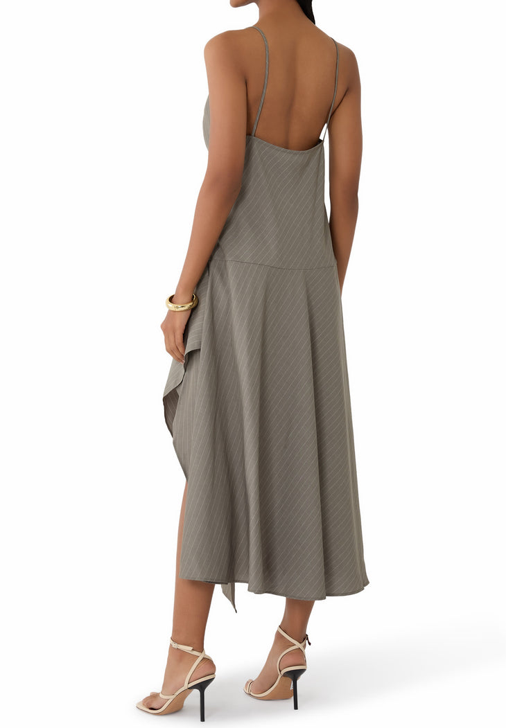 Woman wearing grey pinstriped asymmetric slip dress with thin straps and high slit — St Agni | Endless UAE