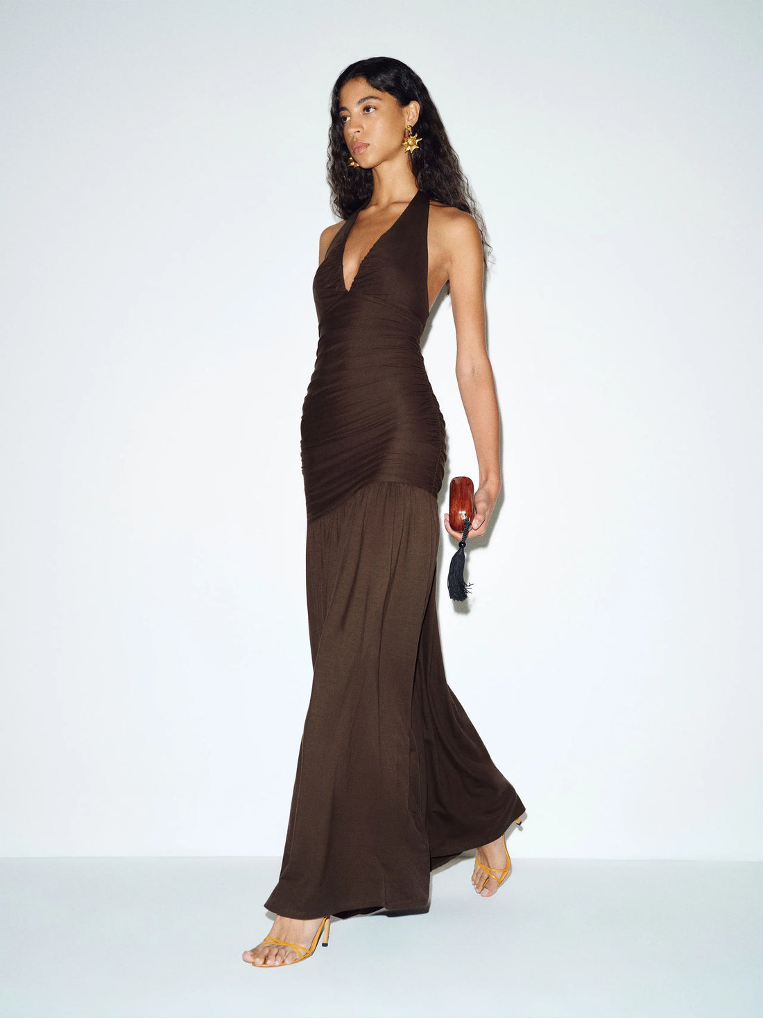 Woman wearing brown halter neck knit maxi dress with flowing skirt — Reformation | Endless UAE