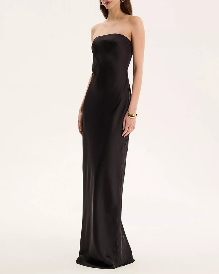 Woman wearing black strapless satin maxi dress — Omnes | Endless UAE