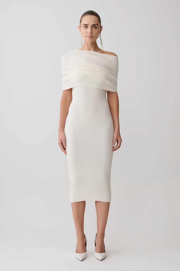 Woman wearing cream cashmere blend knit midi dress with draped off-shoulder overlay and white pointed heels — Meshki | Endless UAE