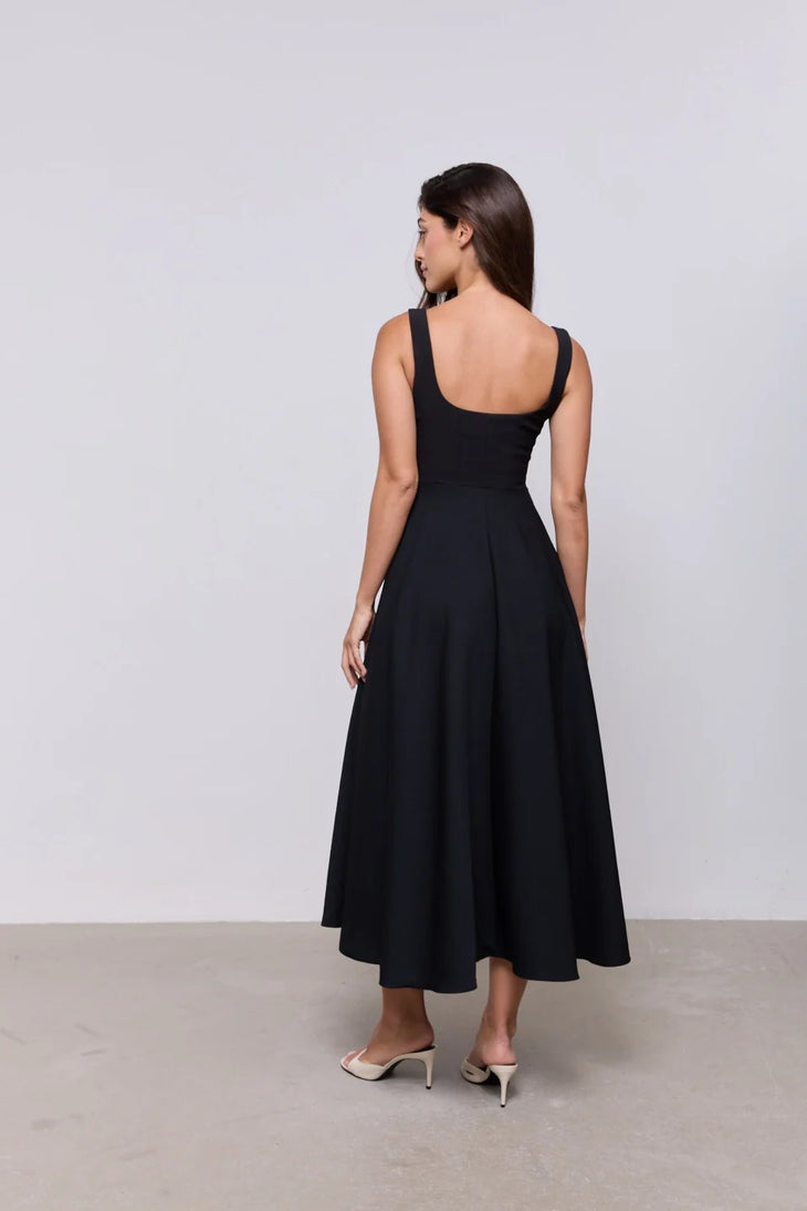 Woman wearing black square neck midi dress with white slides against neutral background — Odd Muse | Endless UAE