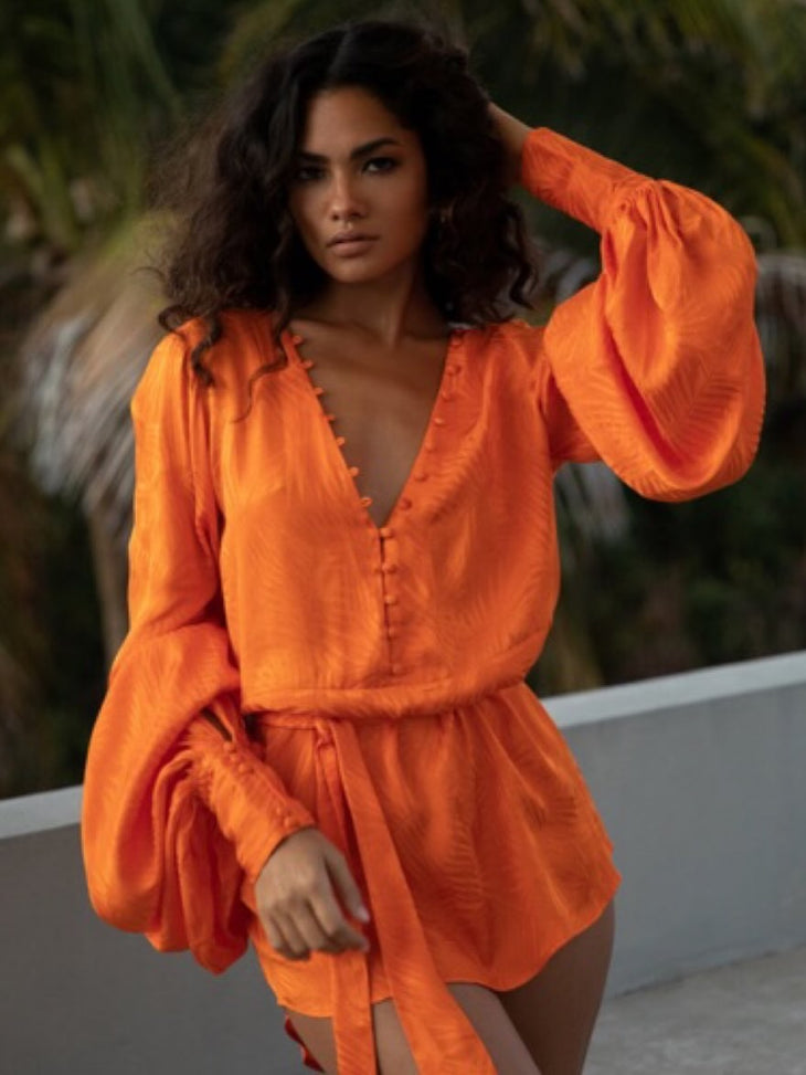 Woman wearing vibrant orange Harlequin Dress by Rat & Boa on curved road — Rat & Boa | Endless UAE