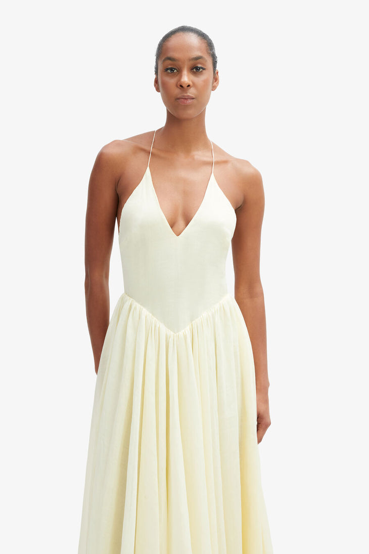 Woman wearing cream halter maxi dress with full skirt and wooden platform sandals — Bardot | Endless UAE