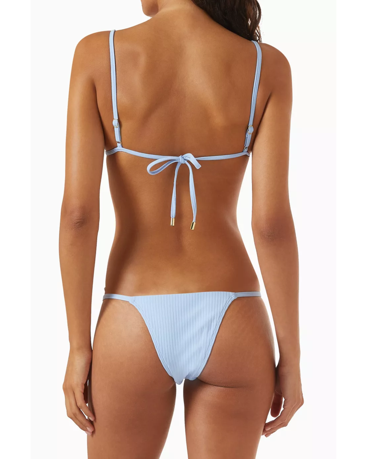 Woman wearing light blue ribbed triangle bikini top and matching bikini bottom — Monday Swimwear | Endless UAE