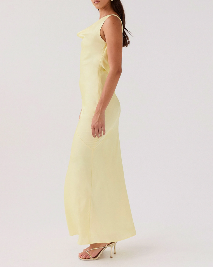 Woman wearing pale yellow satin sleeveless maxi dress with cowl neckline — Peppermayo | Endless UAE