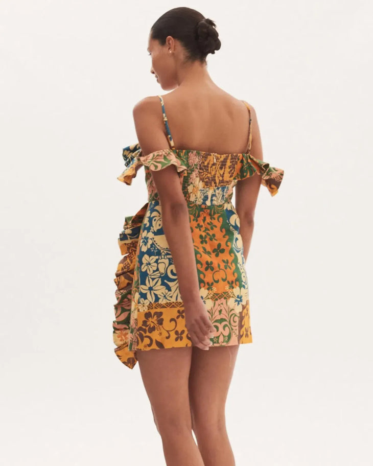 Woman wearing colorful floral patchwork off-shoulder mini dress with ruffled details — Alemais | Endless UAE