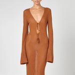 Woman wearing a caramel brown ribbed knit maxi dress with deep V-neckline and tie detail — HYPHEN | Endless UAE