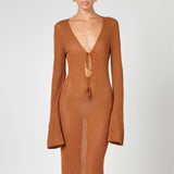 Woman wearing a caramel brown ribbed knit maxi dress with deep V-neckline and tie detail — HYPHEN | Endless UAE