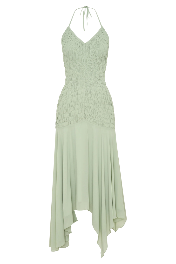 Woman wearing pale green halterneck maxi dress with shirred bodice and asymmetrical hem — Meshki | Endless UAE