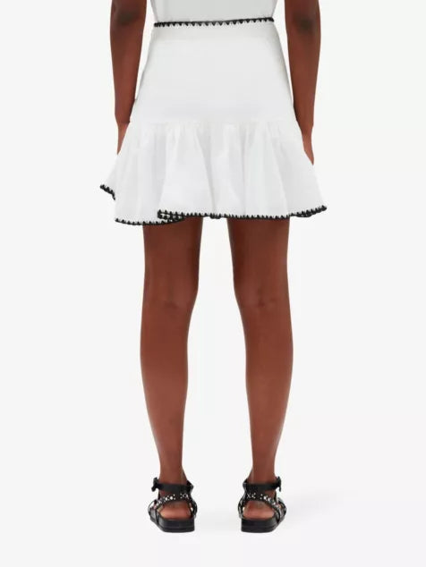White cotton mini skirt with black embroidered ruffle trim — Claudie Pierlot | Endless UAE