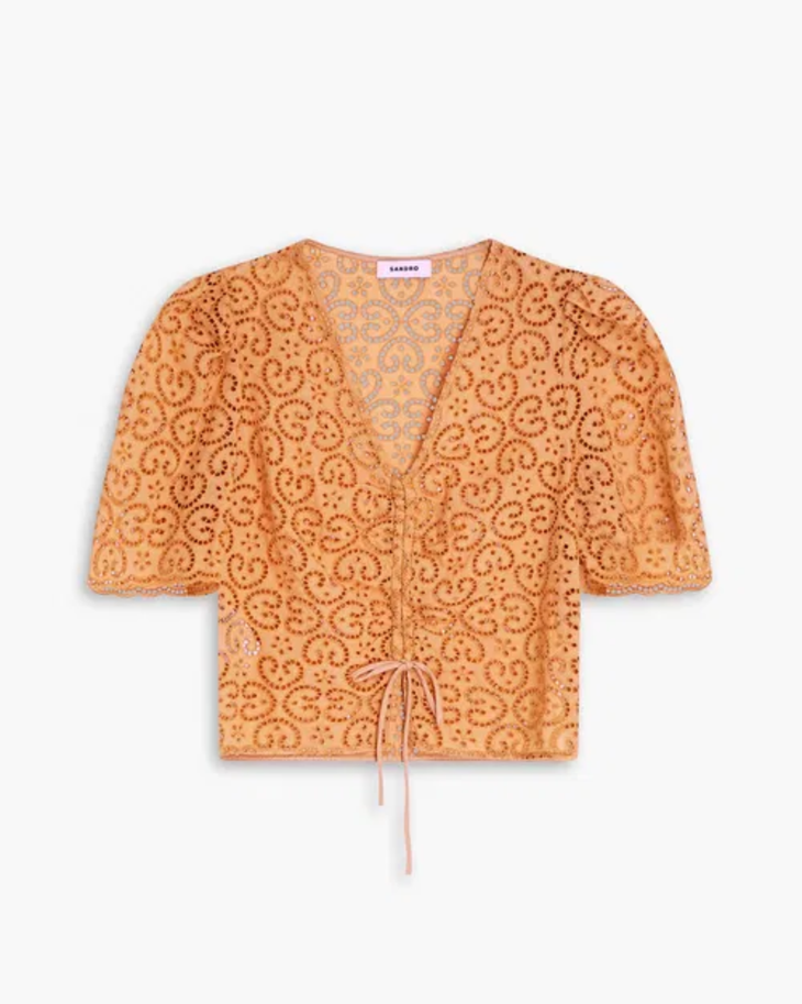 Woman wearing orange broderie anglaise top with matching culottes and woven bag — Sandro | Endless UAE