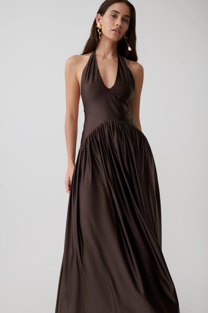 Woman wearing brown halter maxi dress with pleated skirt and gold heeled sandals — Meshki | Endless UAE