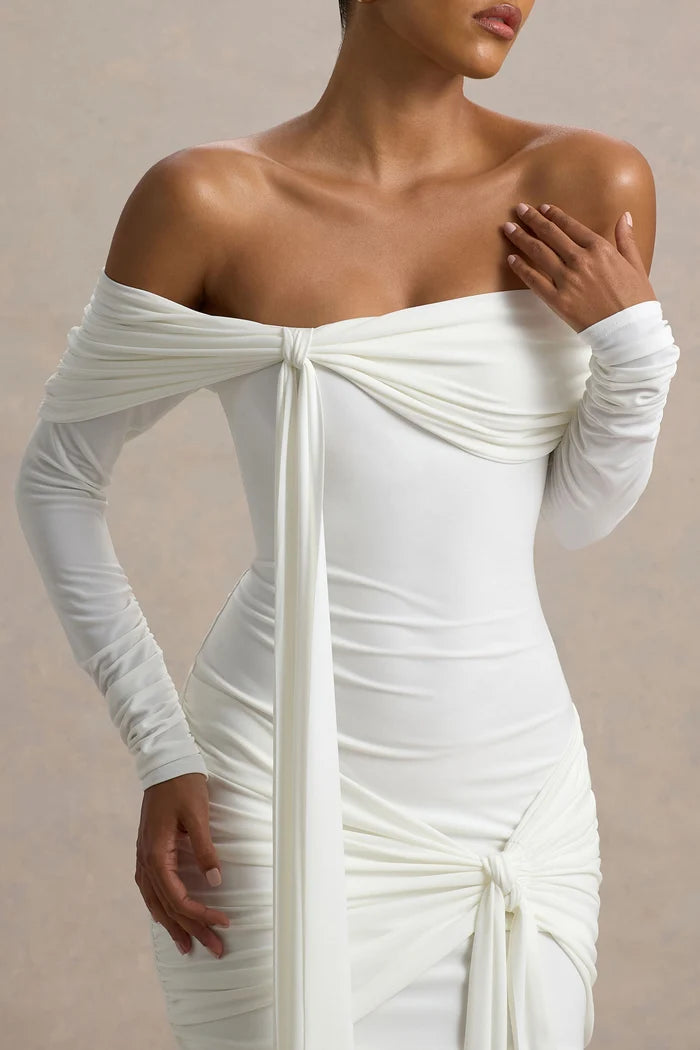 Woman wearing white Bardot wrap mini dress with off-shoulder design and long sleeves — Club L London | Endless UAE