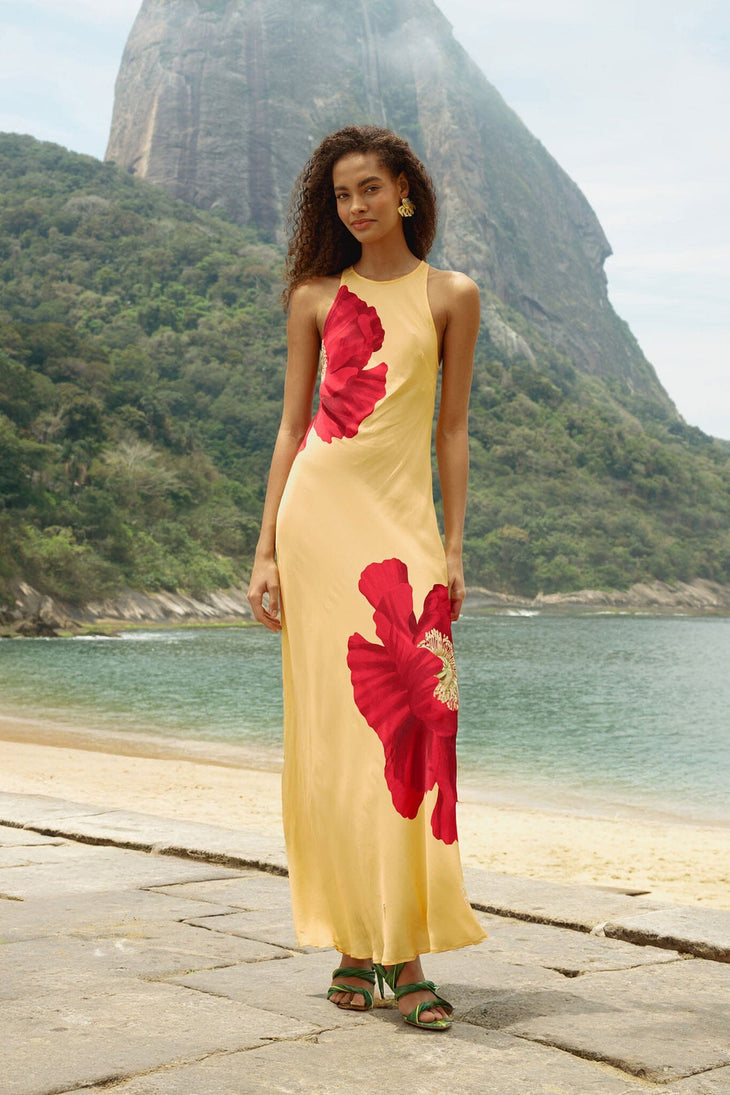 Woman wearing yellow sleeveless maxi dress with red poppy flower print — Farm Rio | Endless UAE