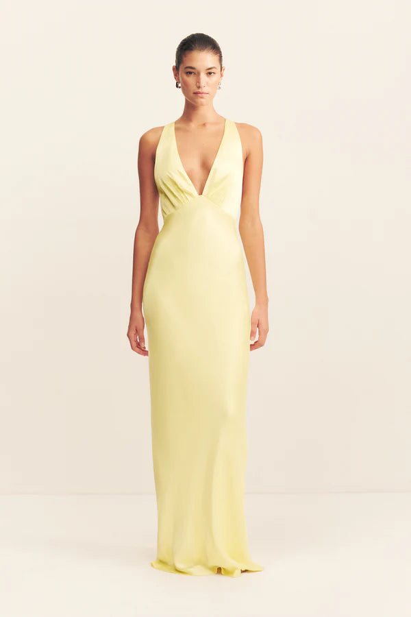 Woman wearing yellow sleeveless plunged neckline maxi dress with cross back detail — Shona Joy | Endless UAE