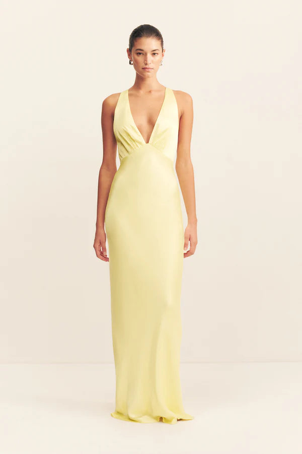 Woman wearing yellow sleeveless plunged neckline maxi dress with cross back detail — Shona Joy | Endless UAE