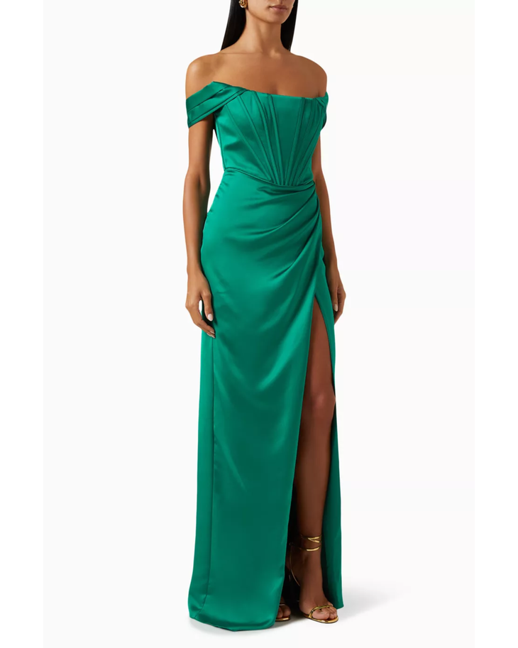 Woman wearing emerald green off-shoulder gown with draped details and high slit — Tarik Ediz | Endless UAE