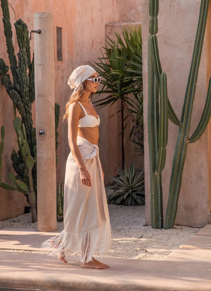 Satin Tassel Sarong in cream worn as beach cover-up — Melissa Phair | Endless UAE