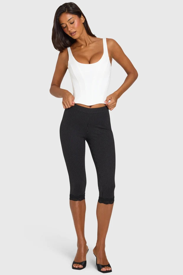 White sleeveless scoop neck corset top paired with black ribbed capri leggings — Oh Polly | Endless UAE