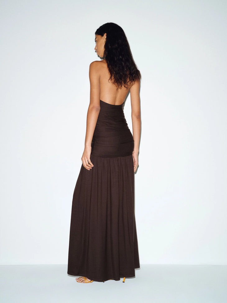 Woman wearing brown halter neck knit maxi dress with flowing skirt — Reformation | Endless UAE