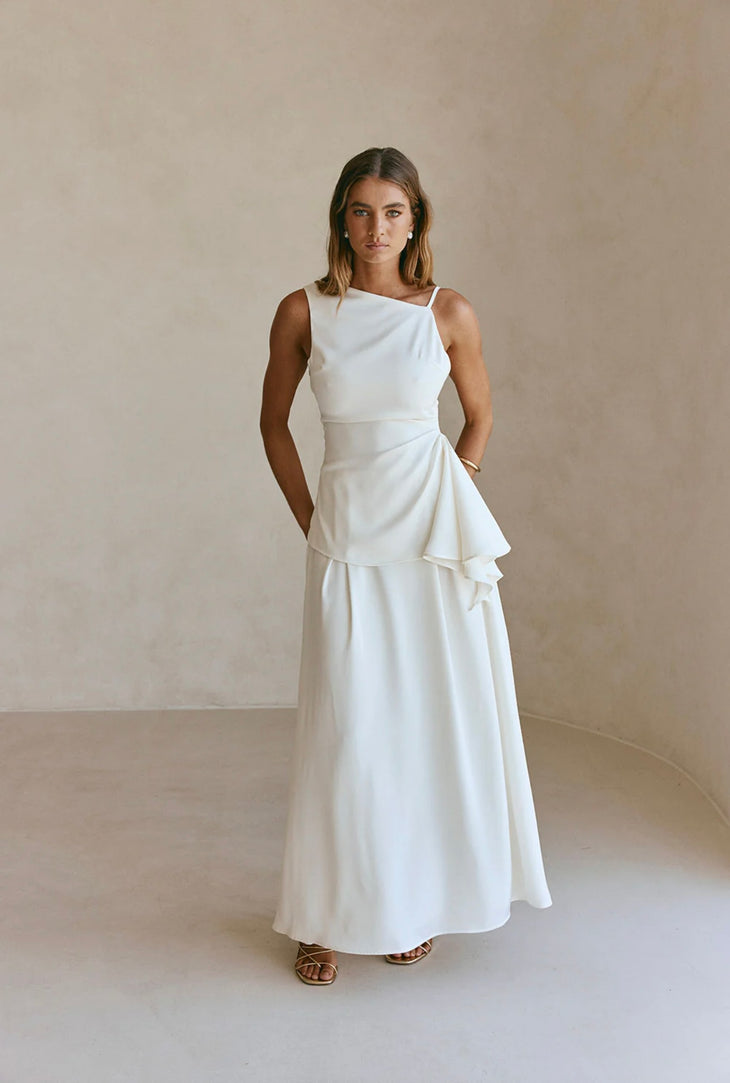 Woman wearing white sleeveless Hailey Co-ord Set with layered skirt and strappy sandals — SABO | Endless UAE