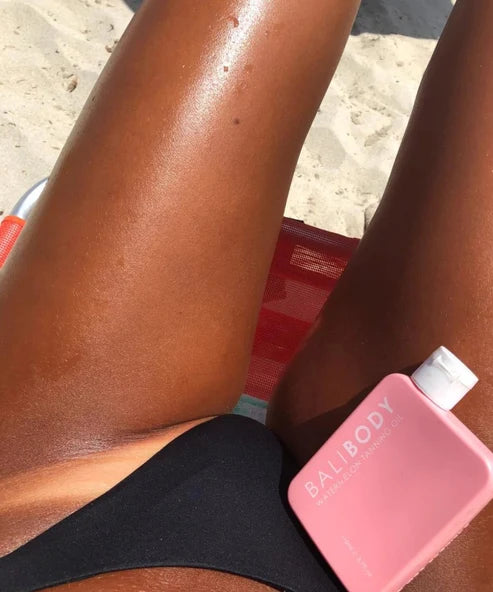 Bali Body Watermelon Tanning Oil SPF6 in pink bottle with white cap — Powder Beauty | Endless UAE