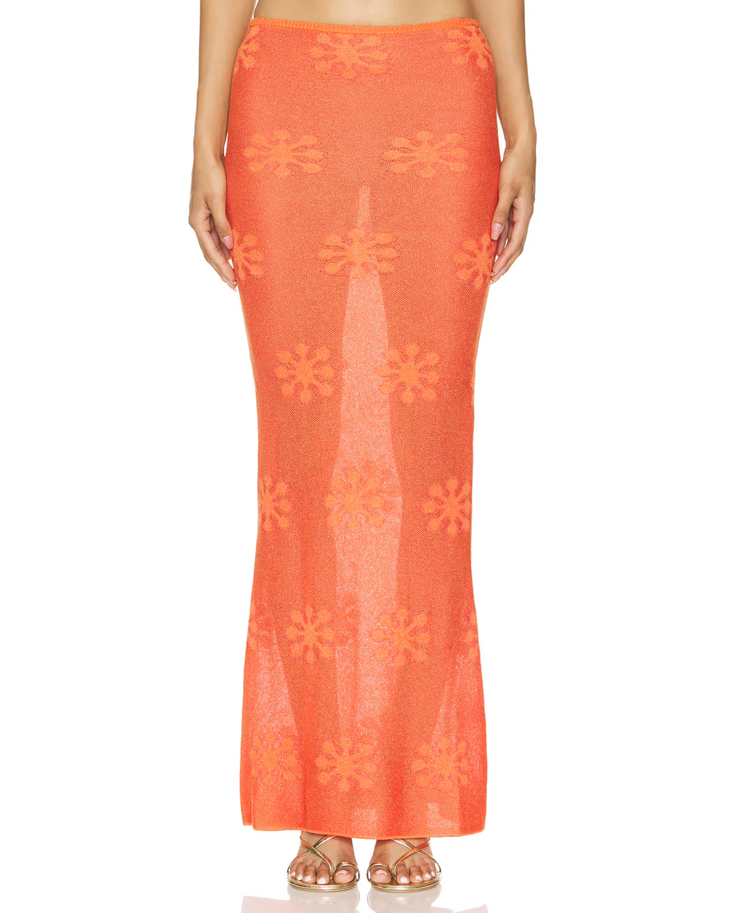 Woman wearing sunset orange crochet maxi dress with floral pattern and thin straps — Asta Resort | Endless UAE