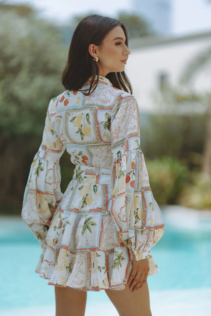 Woman wearing Tessa Linen Mini Dress with fruit print and puffed sleeves — Chic Le Frique | Endless UAE