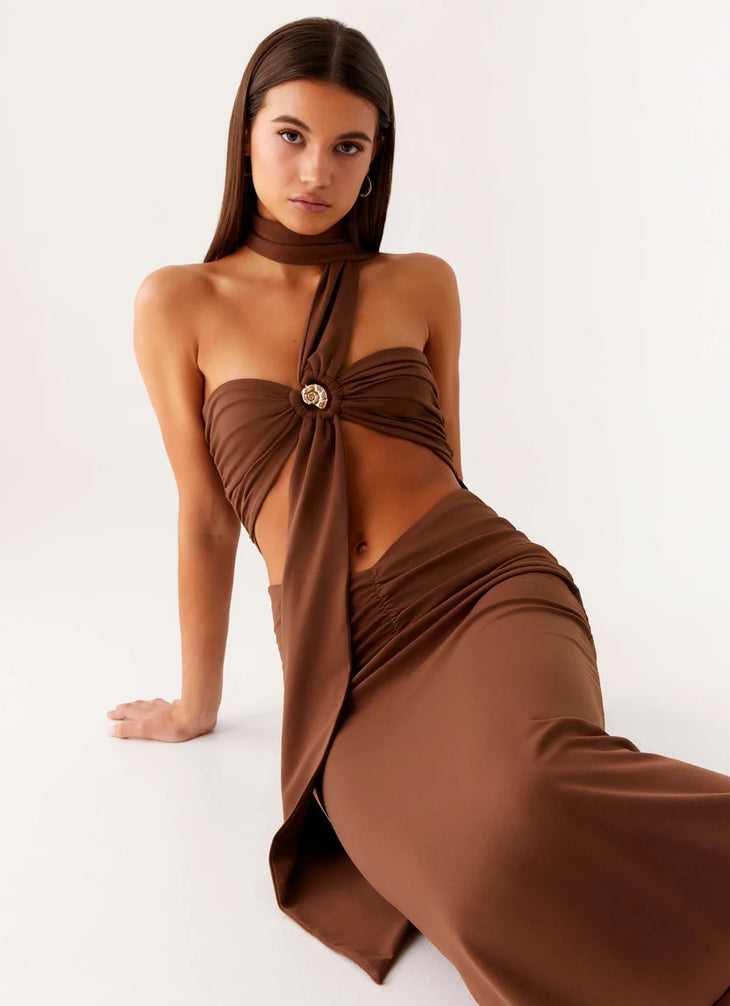 Woman wearing brown halter maxi dress with open back cutout detail — Peppermayo | Endless UAE