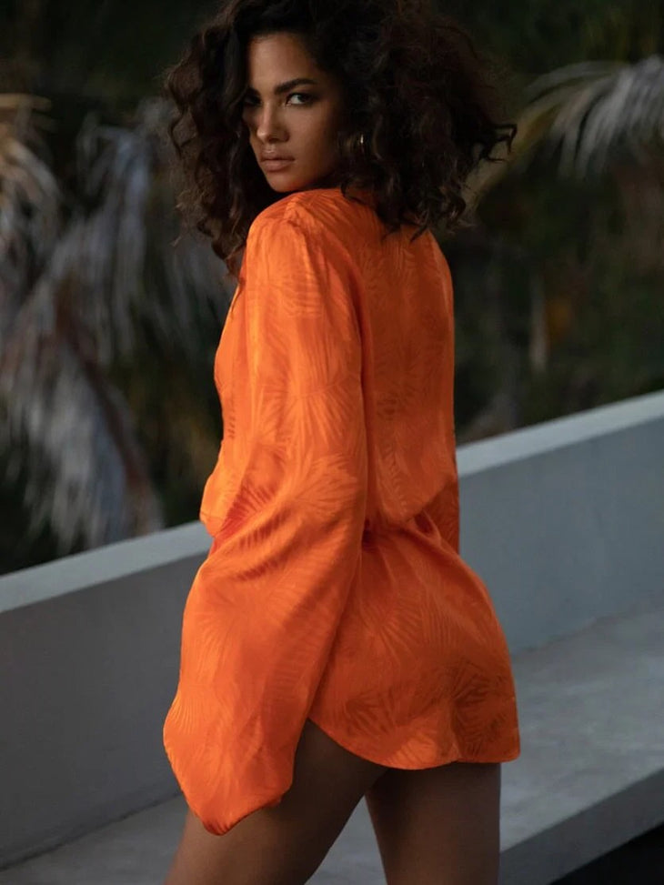 Woman wearing vibrant orange Harlequin Dress by Rat & Boa on curved road — Rat & Boa | Endless UAE