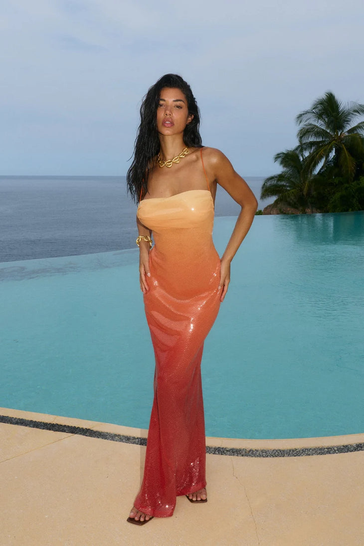 Woman wearing red ombre sequin strapless maxi dress against yellow wall — Bydee | Endless UAE