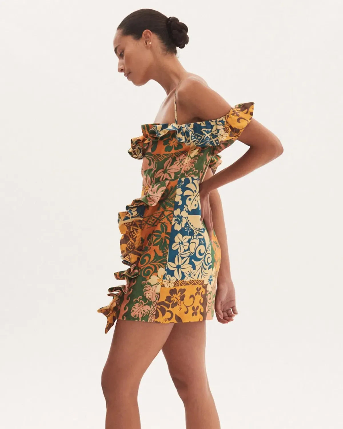 Woman wearing colorful floral patchwork off-shoulder mini dress with ruffled details — Alemais | Endless UAE