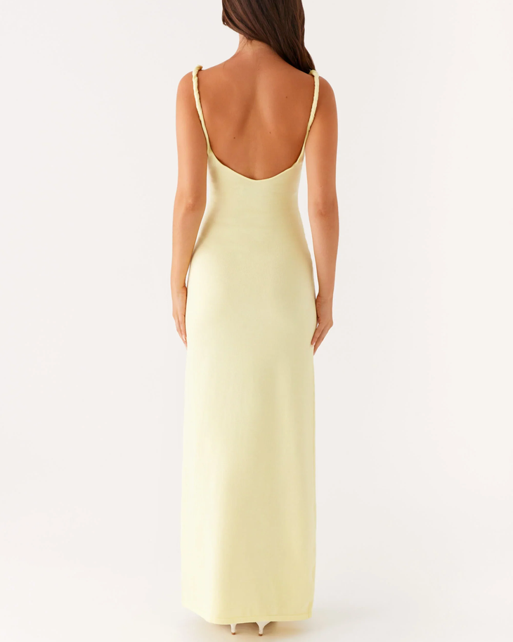 Woman wearing pale yellow sleeveless maxi dress with open back — Peppermayo | Endless UAE