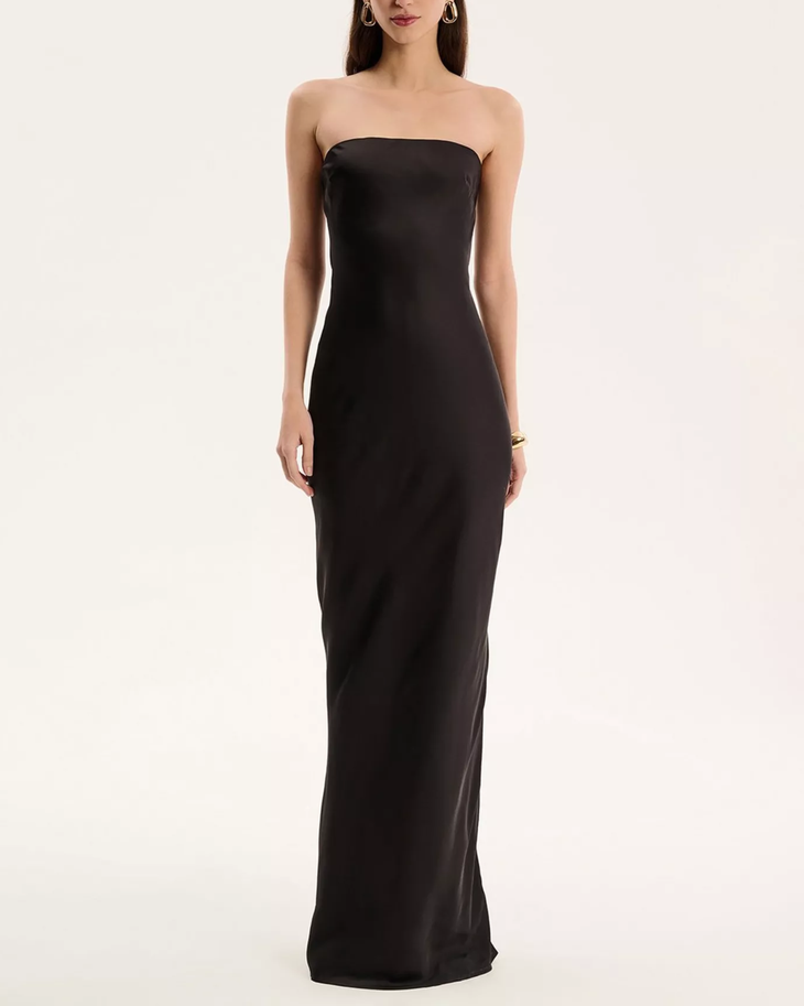 Woman wearing black strapless satin maxi dress — Omnes | Endless UAE