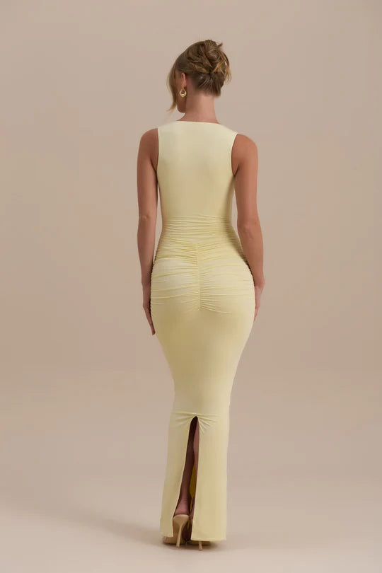 Woman wearing a pale yellow sleeveless maxi dress with ruched detailing — Wanderdoll | Endless UAE