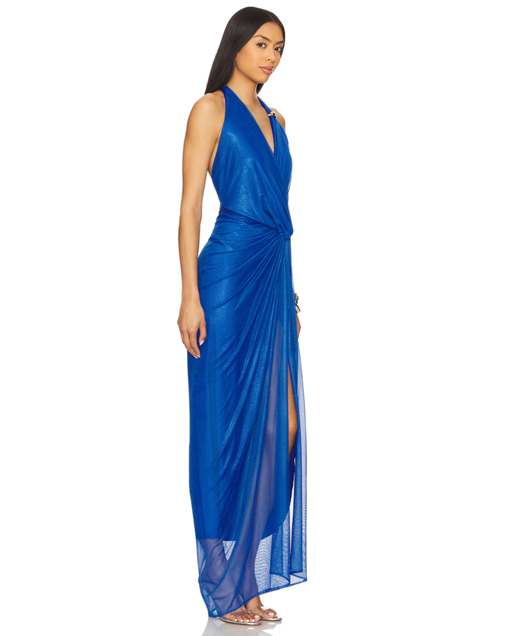 Woman wearing royal blue halter wrap maxi dress with draped side slit and gold accessories — Baobab | Endless UAE