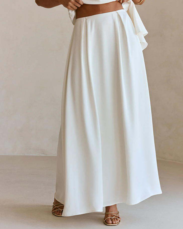 Woman wearing white sleeveless Hailey Co-ord Set with layered skirt and strappy sandals — SABO | Endless UAE