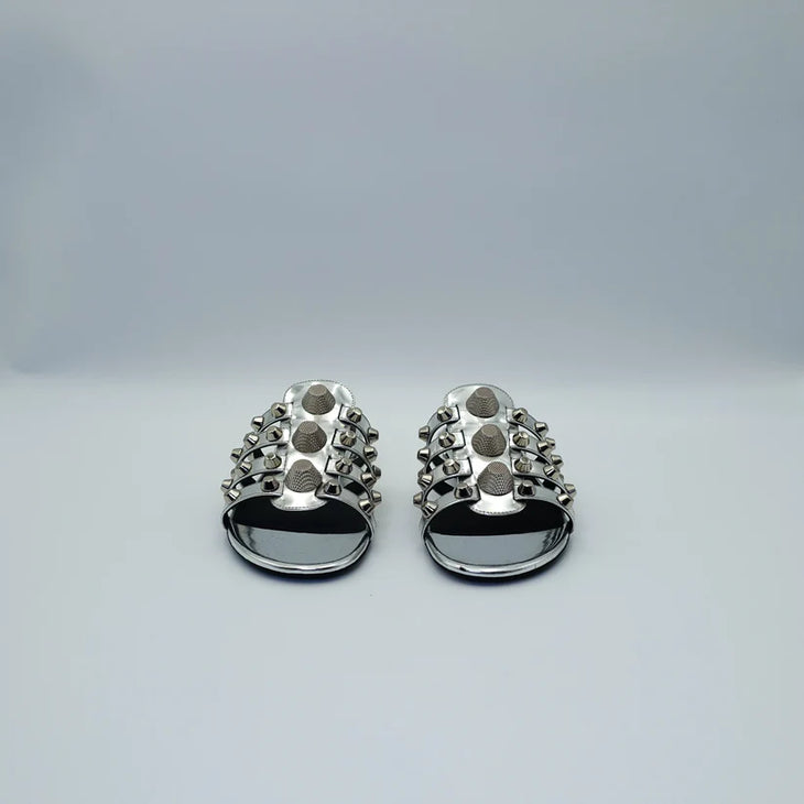 Silver studded flat sandals with black straps and metallic accents — Balenciaga | Endless UAE