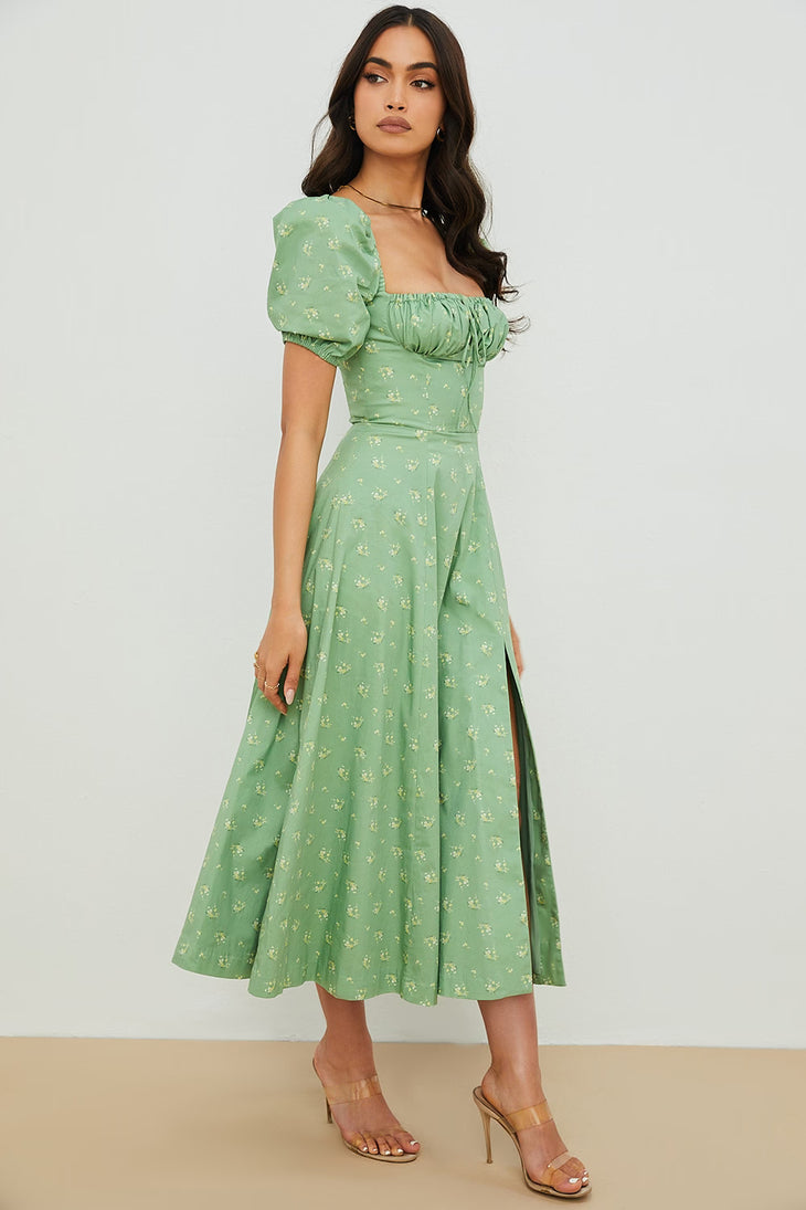 Woman wearing a green floral puff sleeve midi dress with a slit — House of CB | Endless UAE
