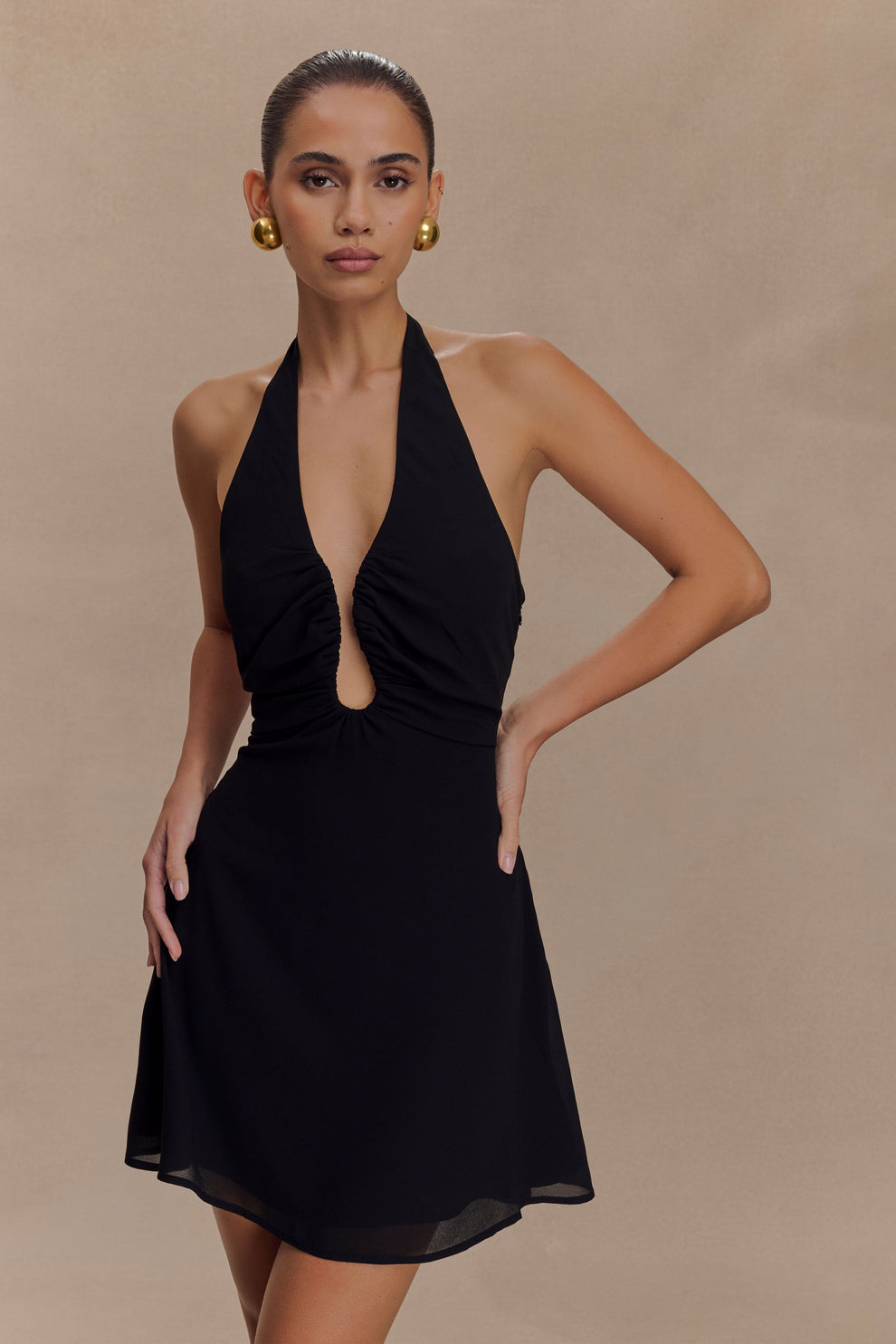 Black halter mini dress with plunging neckline and A-line silhouette — Meshki | Endless UAE