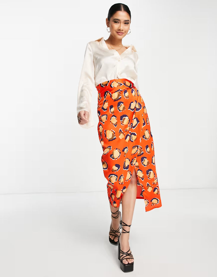 Woman wearing cream blouse and orange leopard print wrap midi skirt with black platform sandals — Never Fully Dressed | Endless UAE