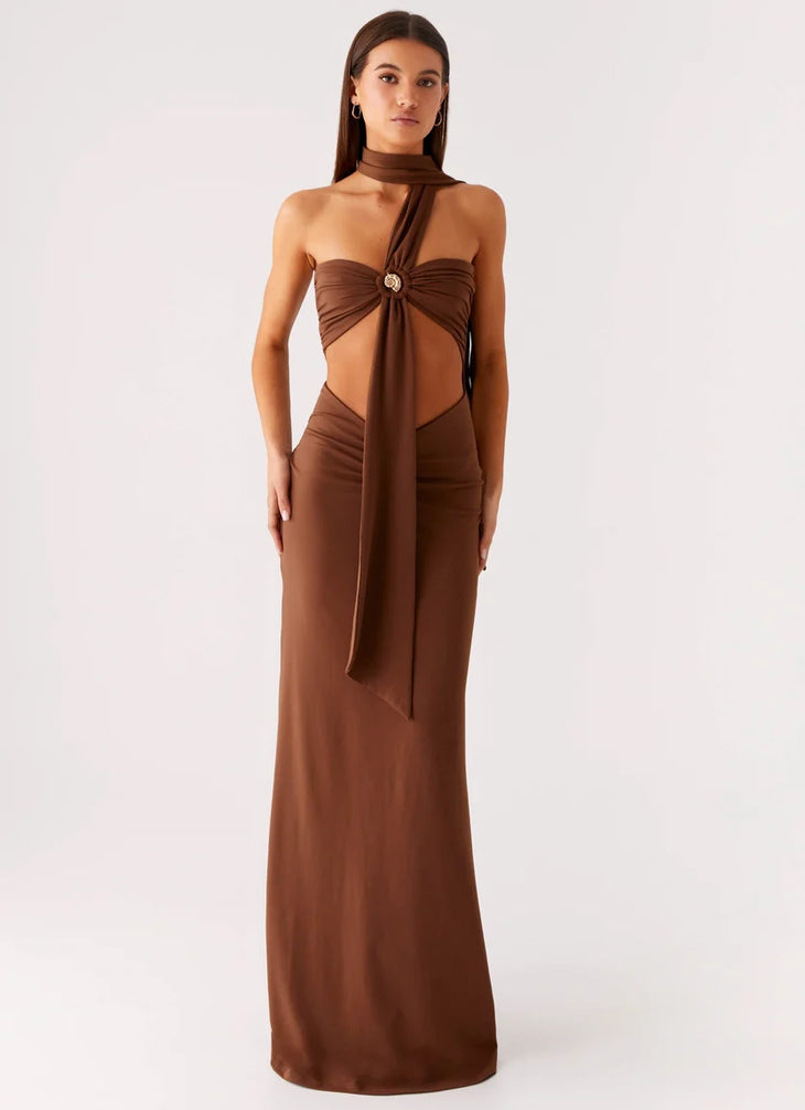 Woman wearing brown halter maxi dress with open back cutout detail — Peppermayo | Endless UAE