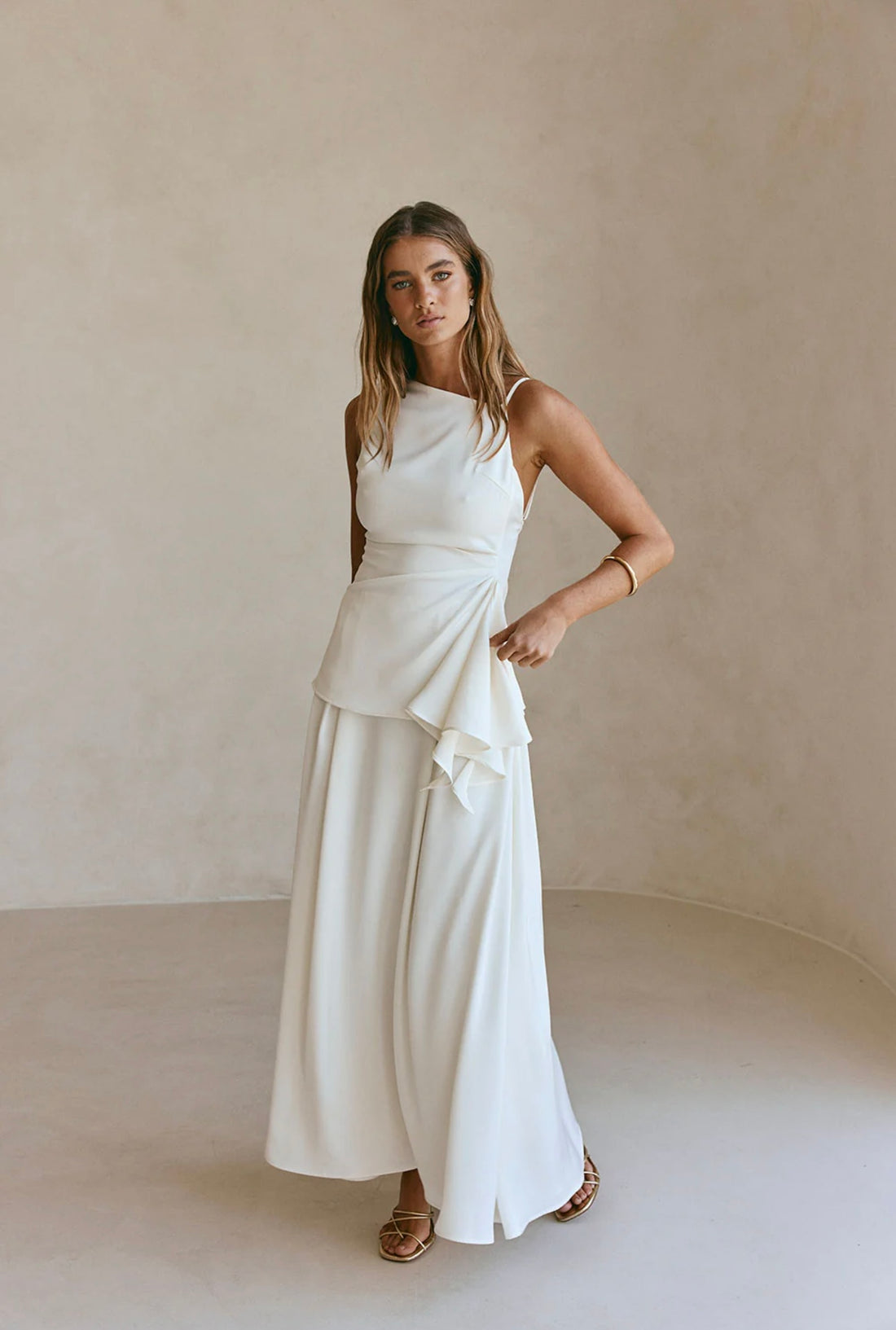 Woman wearing white sleeveless Hailey Co-ord Set with layered skirt and strappy sandals — SABO | Endless UAE