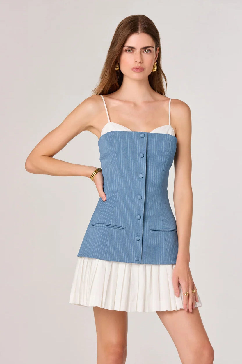 Woman wearing blue pinstriped denim camisole top with white pleated skirt bottom — ASTR the Label | Endless UAE
