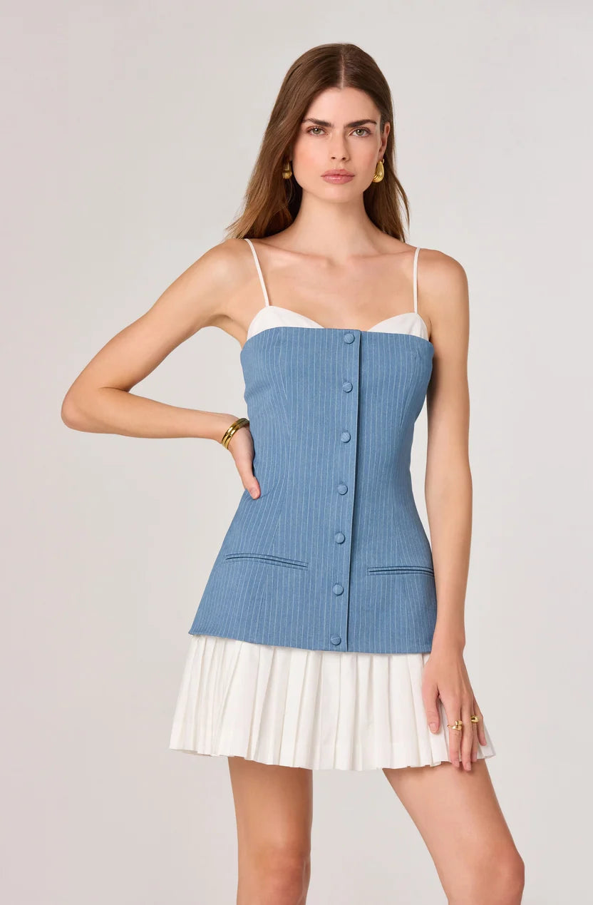 Woman wearing blue pinstriped denim camisole top with white pleated skirt bottom — ASTR the Label | Endless UAE