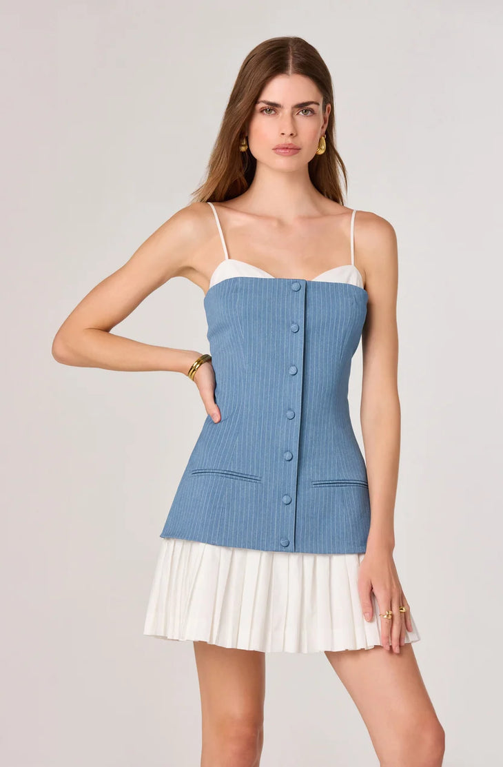 Woman wearing blue pinstriped denim camisole top with white pleated skirt bottom — ASTR the Label | Endless UAE