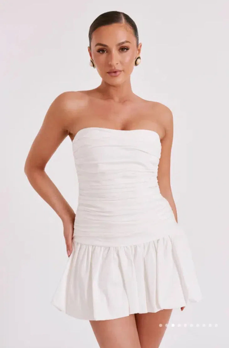 Woman wearing white strapless ruched cotton mini dress with circular earrings — Meshki | Endless UAE