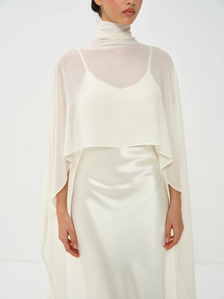 Estelle Cape Maxi Gown in cream with draped cape overlay and turtleneck — Nora The Label | Endless UAE