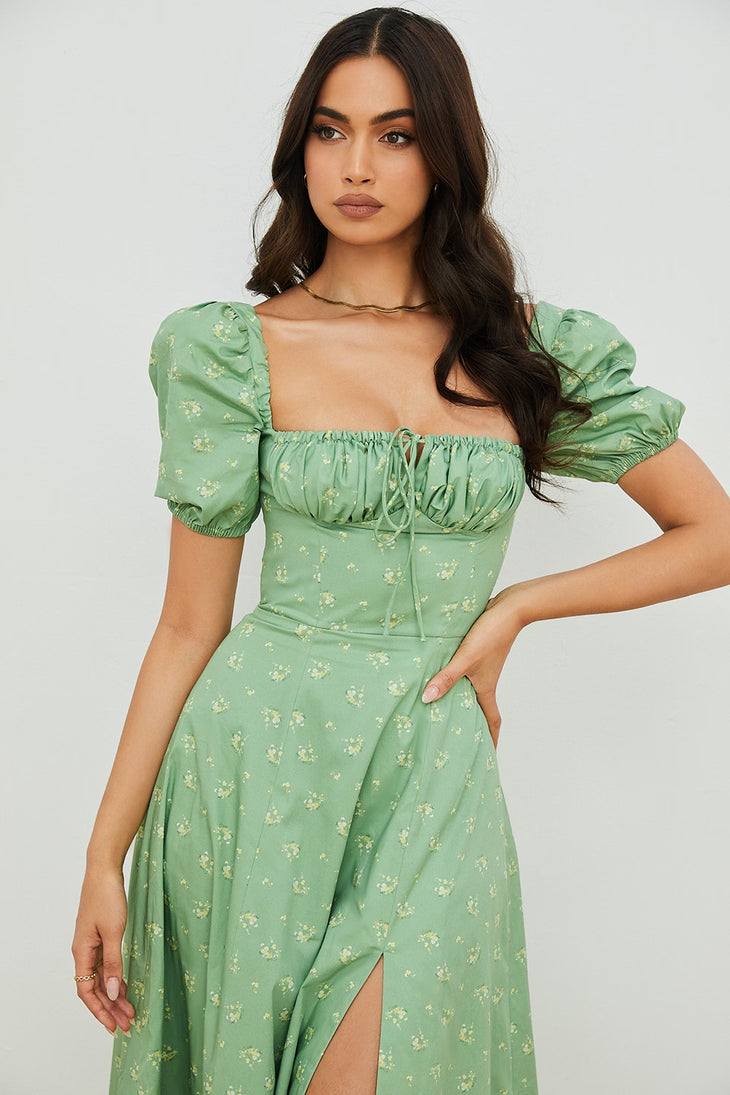 Woman wearing a green floral puff sleeve midi dress with a slit — House of CB | Endless UAE