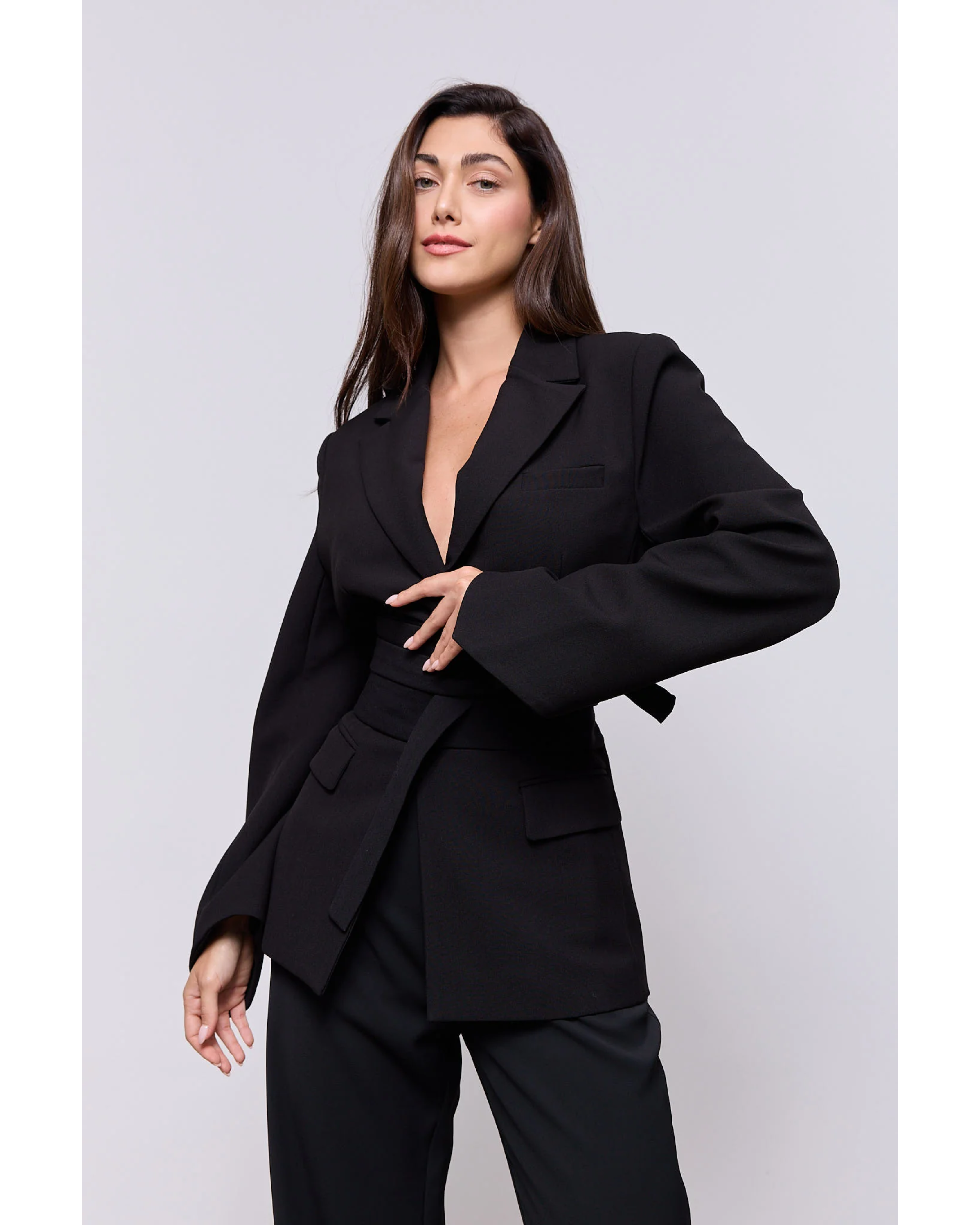Woman wearing a black belted blazer with long sleeves and matching trousers — Odd Muse | Endless UAE